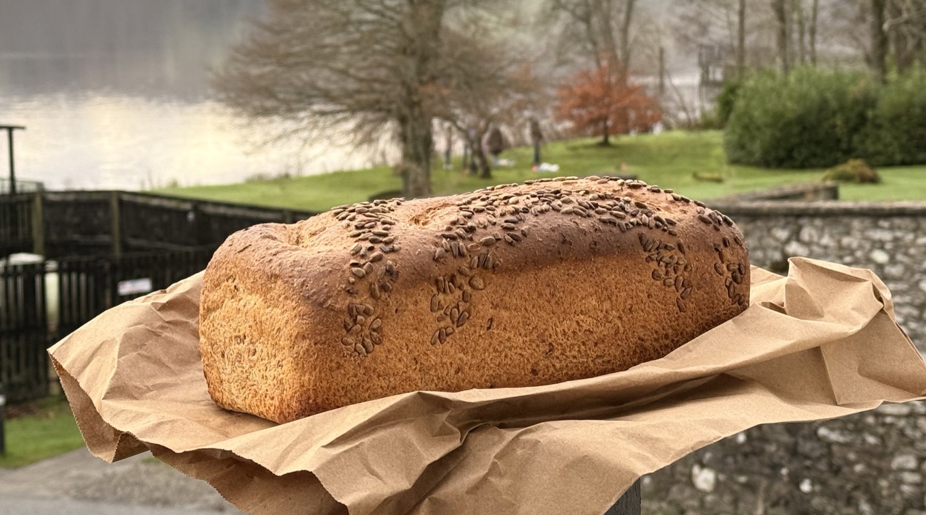 A sliced homemade wholemeal loaf on brown paper